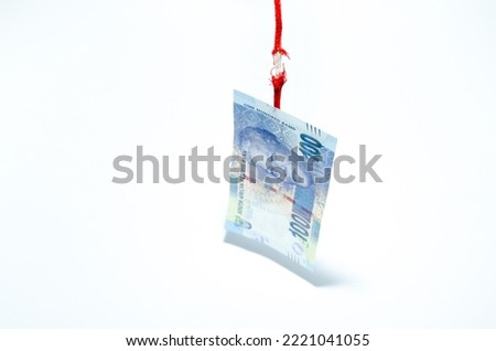 South-Africa rand is near collapsing while its hanging on a thread with zar note and damaged rope on white background