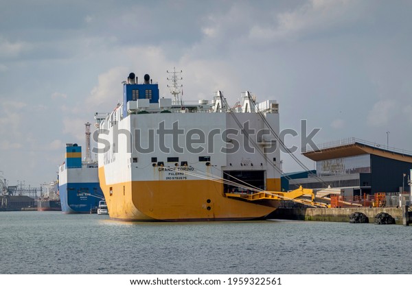 Southampton, England, UK. 2021.  Car carrier ship with\
extending loading ramp alongside in the Port of Southampton,\
England, UK. 