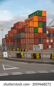 Southampton, England, UK. 2021. Shipping Containers Stacked High In A Container Port Dwarfed By Dockside Gantry Cranes. UK