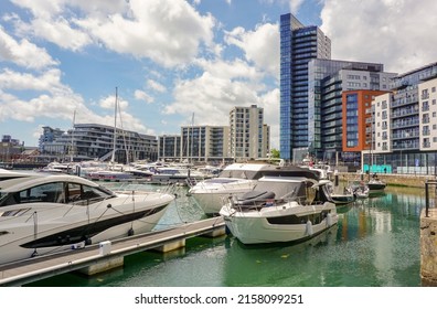 Southampton, Hampshire, England - 05.19.2022 : View over Ocean Village Marina in port city of Southampton. Various yachts and boats moored with modern apartments and restaurants in background 