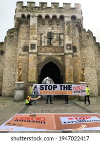 Southampton, UK - 31th March 2021: A Group Of Protesters Hold Up A Banner Outside Of The Southampton Bargate,. The Banner Reads Stop The Explotation, Amazon Stop Union Busting, Action On Amazon. 