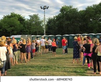 SOUTHAMPTON, UK - July 8 2017: Lets Rock Southampton, 80s music festival, in Southampton UK. People standing in a line waiting to use the portable toilets. 