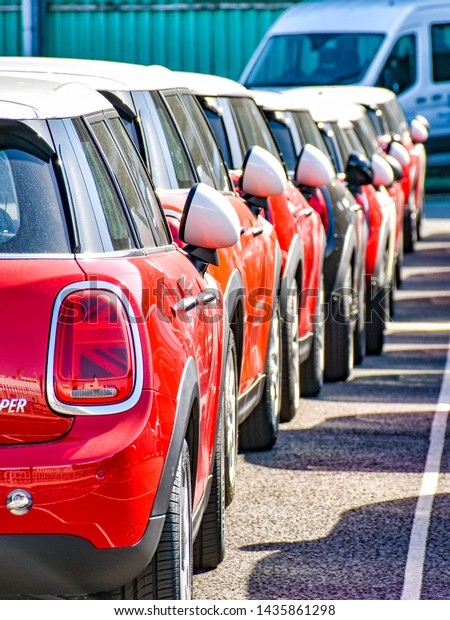 Southampton, United Kingdom – August 6, 2018:\
MINI Cooper cars are ready for shipment in a row in the port of\
Southapton (United\
Kingdom).
