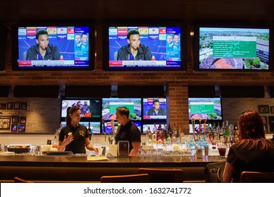 SOUTHAMPTON, UNITED KINGDOM - Jun 01, 2019: Staff Behind A Sports Bar On A Royal Caribbean Cruise Ship Independence Of The Seas