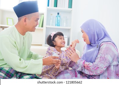 Southeast Asian Child Feeding Mother Yogurt. Malay Muslim Family Living Lifestyle