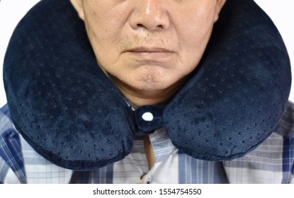 Southeast Asian, Chinese Old Man Taking A Nap On Neck Pillow During Daytime In His Home. Tiredness Can Cause Sleepy. Isolated On White Background.