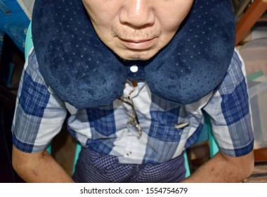 Southeast Asian, Chinese Old Man Taking A Nap On Neck Pillow During Daytime In His Home. Tiredness Can Cause Sleepy.