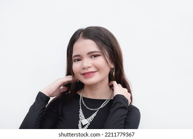 A Southeast Asian female smiling for the camera for a studio shot isolated on a white background. - Shutterstock ID 2211779367