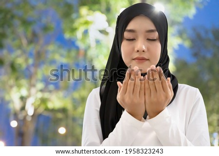 Southeast asian muslim woman in evening prayer, concept of Islamic people during Ramadan fasting, Religious Muslim woman, good Muslimah, Ramadan Kareem, Eid Mubarak, Eid ul Fitr, Eid ul Adha