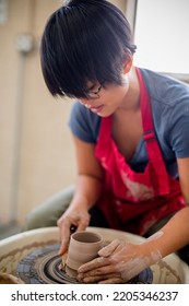 Southeast Asian Woman Making Pottery In A Pottery Studio