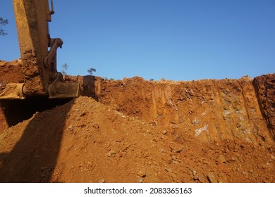 Southeast Sulawesi, November 23th 2021, Indonesia. Bucket of excavator machine digging for nickel ore at mining site on sky background. nickel ore production, nickel open pit mine.