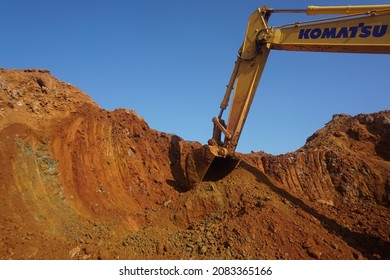 Southeast Sulawesi, November 23th 2021, Indonesia. Bucket of excavator machine digging for nickel ore at mining site on sky background. nickel ore production, nickel open pit mine.