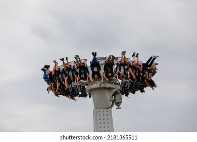 Southend-on-Sea, UK  July 21st 2022  People Hanging Upside Down On A Pendulum Swing Ride In An Amusement Park. Seen From Elevated Position