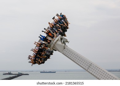 Southend-on-Sea, UK  July 21st 2022  A Pendulum Ride, Amusement Park Swing Ride Falling Downwards With Riders Arms And Legs Flailing