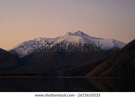 Southern Alps idyllic remote calm serene golden hour snow capped mountain peaks, Lake Heron winter sunset landscape, Ashburton Lakes Canterbury South Island New Zealand