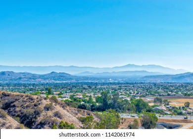 Southern California Houses Below In Inland Empire On Hot Summer Morning With Mountains In The Distance