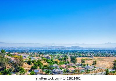 Southern California Inland Empire On Hot Summer Day With Haze In The Distance And Blue Sky For Copy Text