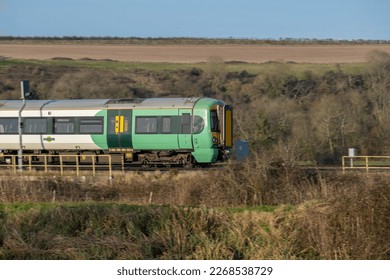 Southern Class 377 multiple unit travelling through countryside (Arundel)