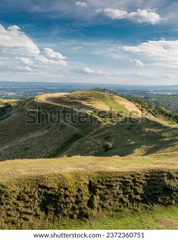 Southern end of Malvern Hills,beautiful smooth rolling hillsides,popular walking area,beautiful views across the ancient hillfort,towards rural Gloucestershire,on a sunny summer's late afternoon.