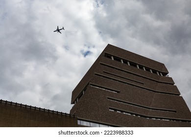 Southwark, London, United Kingdom - August 29th 2022: The Switch House Extension To The Tate Modern Gallery By Herzog De Meuron An Imposing Brick Structure With An Aeroplane Flying Overhead