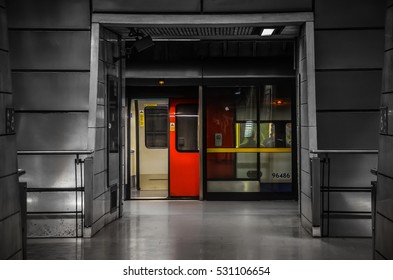 Southwark Station, London - November 2016 - Train waits for passengers at Southwark Station. The strong primary colours of the tube train contrast with the modern architecture.