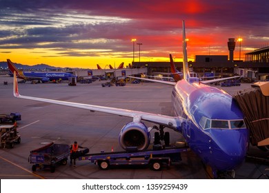Southwest Airlines Boeing 737 airplanes prepare for their next flight at Phoenix Sky Harbor International Airport, at sunset on March 21, 2019.