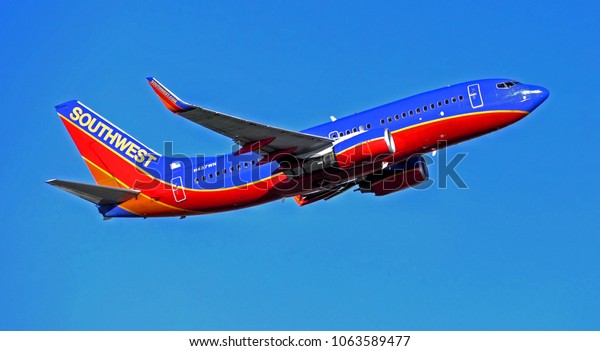 Southwest Airlines jet plane departure climbs\
skyward after taking off from the runway - Logan Airport Boston,\
Massachusetts USA - August 30,\
2014