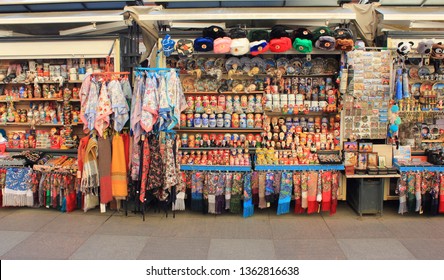 Souvenir Shelf At Gift Shop Window Stall. Traditional Russian Nesting Matryoshka Dolls And In Row On Shelves At Outdoor Market Souvenir Store Display In Saint Petersburg, Russia - 02.04.2019