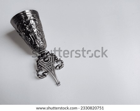 souvenirs from paris in the form of a bell and eiffel tower made of light iron with isolated white background and copy space