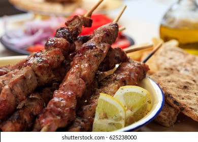 Souvlaki Dish, Greek Food. Grilled Meat Skewers And Pita Bread In A Dish. Closeup View