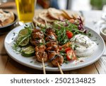 Souvlaki skewers with grilled meat and vegetables arranged on a plate, professional food photo, angle view composition showcasing Mediterranean cuisine.