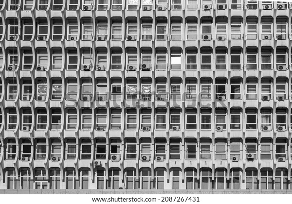 Soviet architecture. Facade of gray building\
with windows background