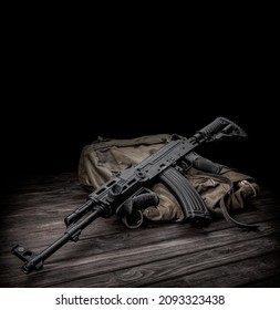 Soviet carbine in modern body kit. Weapons of Russia and the Soviet Union. Classic Soviet AK machine gun on a wooden background.