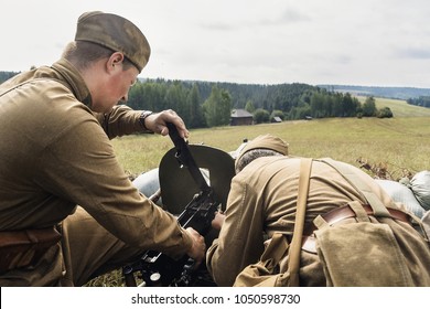 Soviet soldiers loading Maxim machine gun before battle during World war 2, historical reenactment