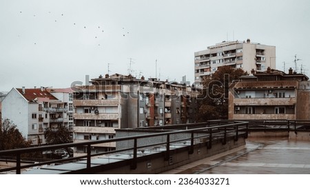 Soviet type city on a dark rainy day with old buildings.