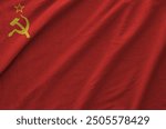 Soviet Union flag depicted on folded wavy fabric of old cloth close up