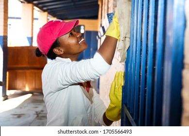 Soweto, South Africa - July 21, 2012: African Women performing community service volunteer cleaning work at township school