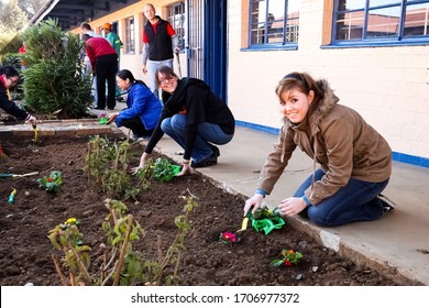 Soweto, South Africa - July 21, 2012: Diverse People Performing Community Service Gardening At Local Township School