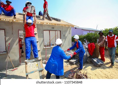 Soweto, South Africa, September 10, 2011,  Diverse Community Members Building A Low Cost House As A Team In Soweto