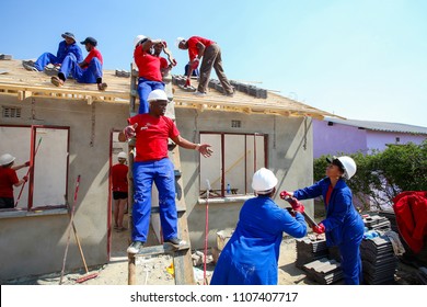 Soweto, South Africa, September 10, 2011,  Diverse Community Members Building A Low Cost House As A Team In Soweto