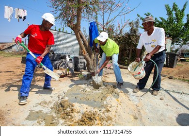 Soweto, South Africa, September 10, 2011,  Diverse Community Members Building A Low Cost House As A Team In Soweto