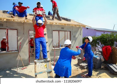 Soweto, South Africa, September 10, 2011,  Diverse Community Members Building A Low Cost House As A Team In Soweto