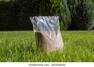 Sowing Grass, Setting Up A Lawn. Foil Packaging With Grass Seeds. 