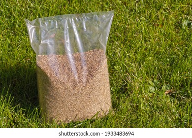 Sowing Grass, Setting Up A Lawn. Foil Packaging With Grass Seeds. 