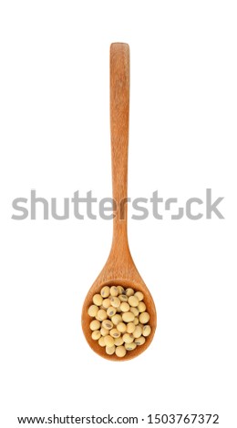 Soy beans in woodenspoon  isolated  on white background