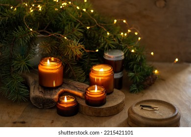Soy candles burn in glass jars. Comfort at home. Candle in a brown jar. Scent and light. Scented handmade candle. Aroma therapy. Christmas tree and winter mood. Cozy home decor. Festive decoration. - Shutterstock ID 2215421101