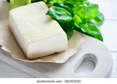 Soy Cheese Tofu On A Cutting Board, Basil Closeup