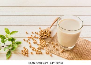Soy milk in glass and soy bean on spoon it on white table background,healthy concept. - Shutterstock ID 644160283