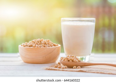 Soy milk in glass and soy bean on spoon it on white table background with lighting in the morning,healthy concept. - Shutterstock ID 644160322