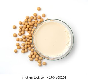 Soy milk and soybeans in a glass on a white background. View from above